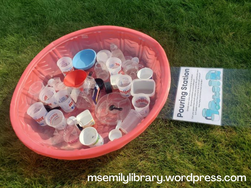 Pouring station, with a faded red baby pool filled with various plastic containers of all shapes and sizes