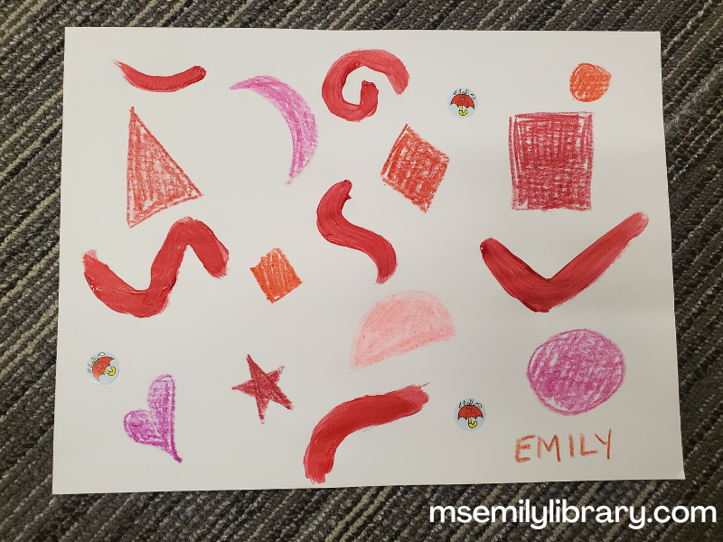 Abstract art with red shapes made by different shades of red crayons, painted squiggles, and stickers of a red umbrella.