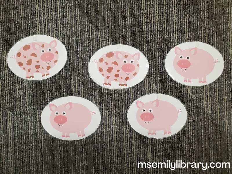 flannelboard pieces for Five Pigs So Squeaky Clean - five printed and laminated ovals containing a cartoon pig in each. The first two have brown splotches on them, the last three are clean pink. The dirty pigs face right and the clean pigs face left.