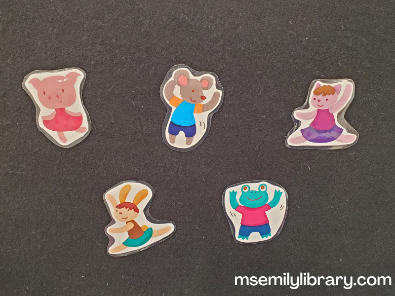printed and laminated flannelboard showing five animals dancing. A pig in a dress, a mouse in shorts, a lavender cat doing splits, a bunny executing a jeté leap, and a frog in shorts waving his arms.