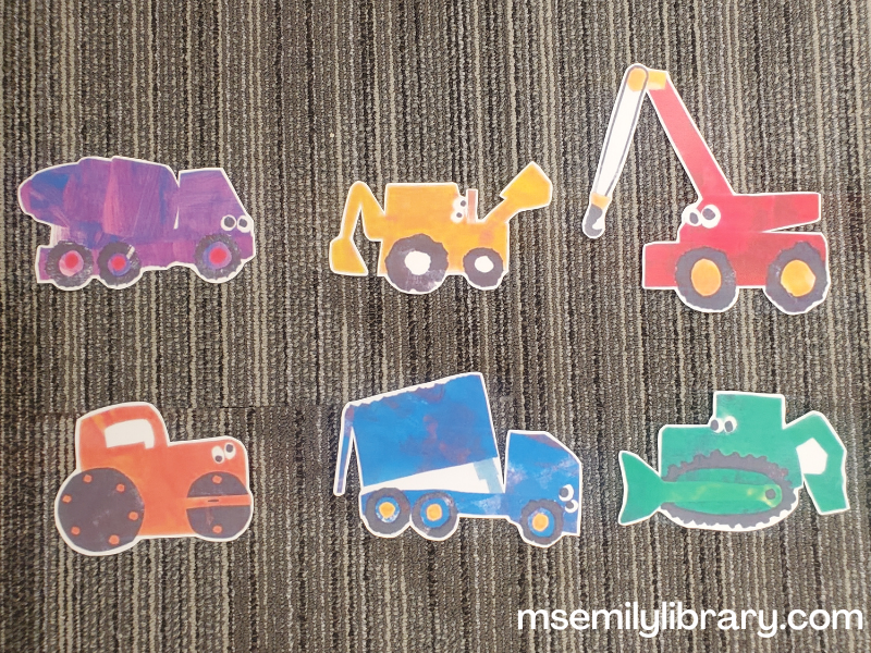 printed pieces for "red crane" flannelboard, showing a purple cement mixer, yellow digger, red crane, orange road roller, blue dump truck, and green bulldozer.